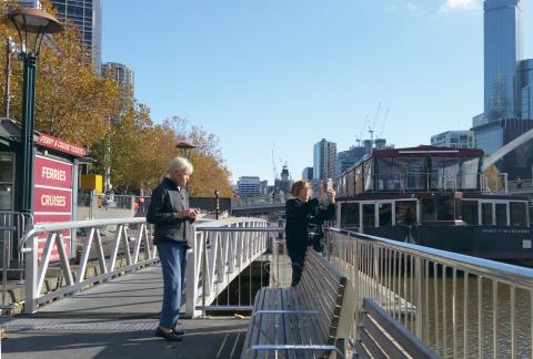 A photo of Judy taking a photo of the Yarra. Mum looks  on.