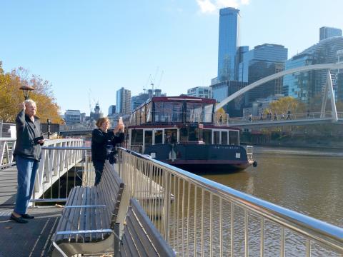 Judy taking a photo of the Yarra, Mum squinting up at the sky.